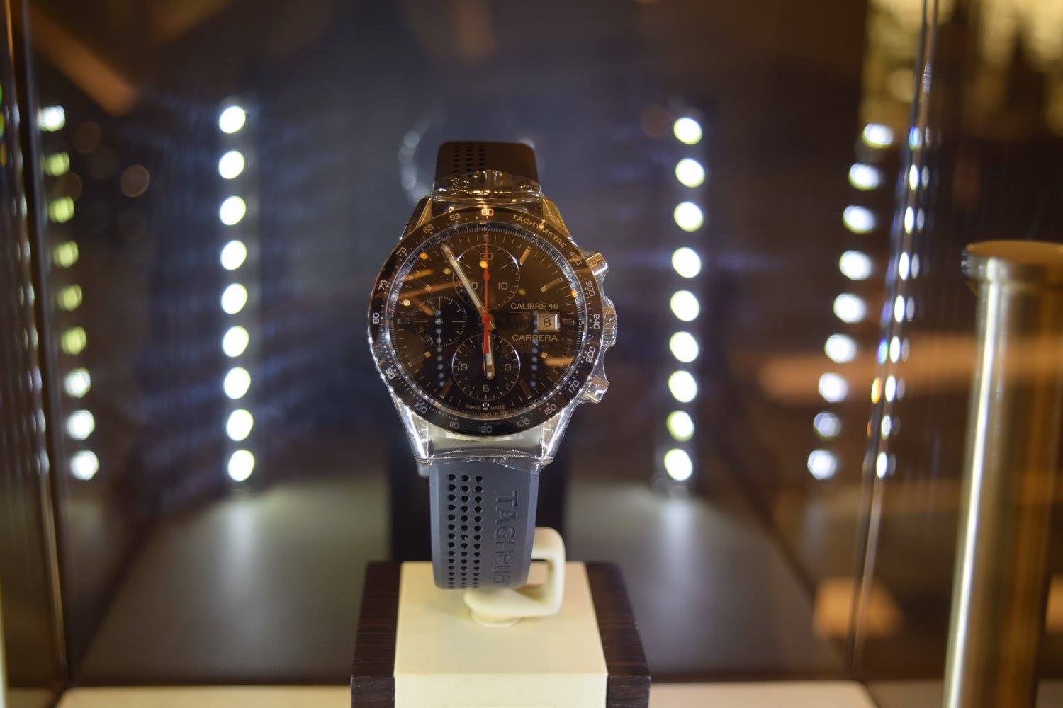Luxurious watch inside glass box in a store.